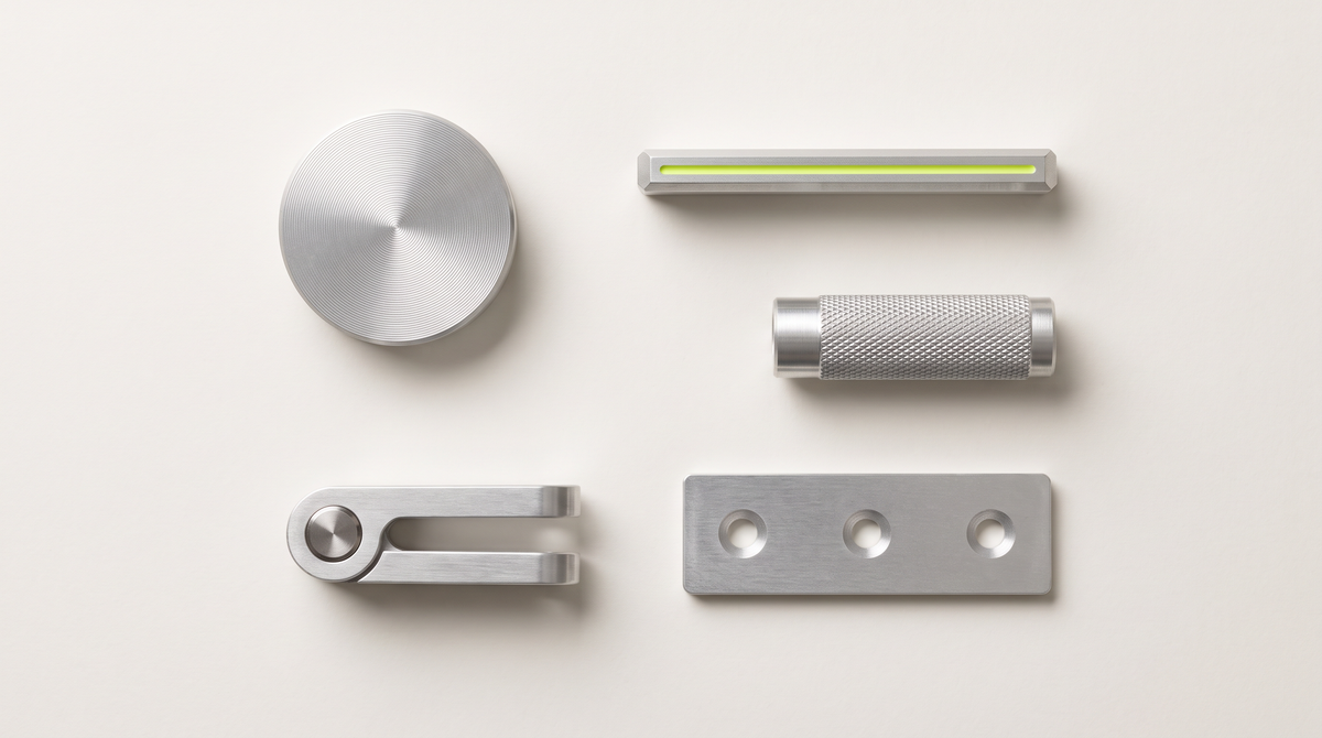 Five metal objects laid out in a row on a pale surface.
