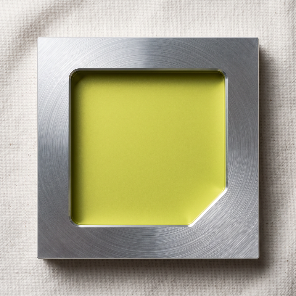 The MagVolt mark engraved into a brushed metal face, the cut catching light along one edge.